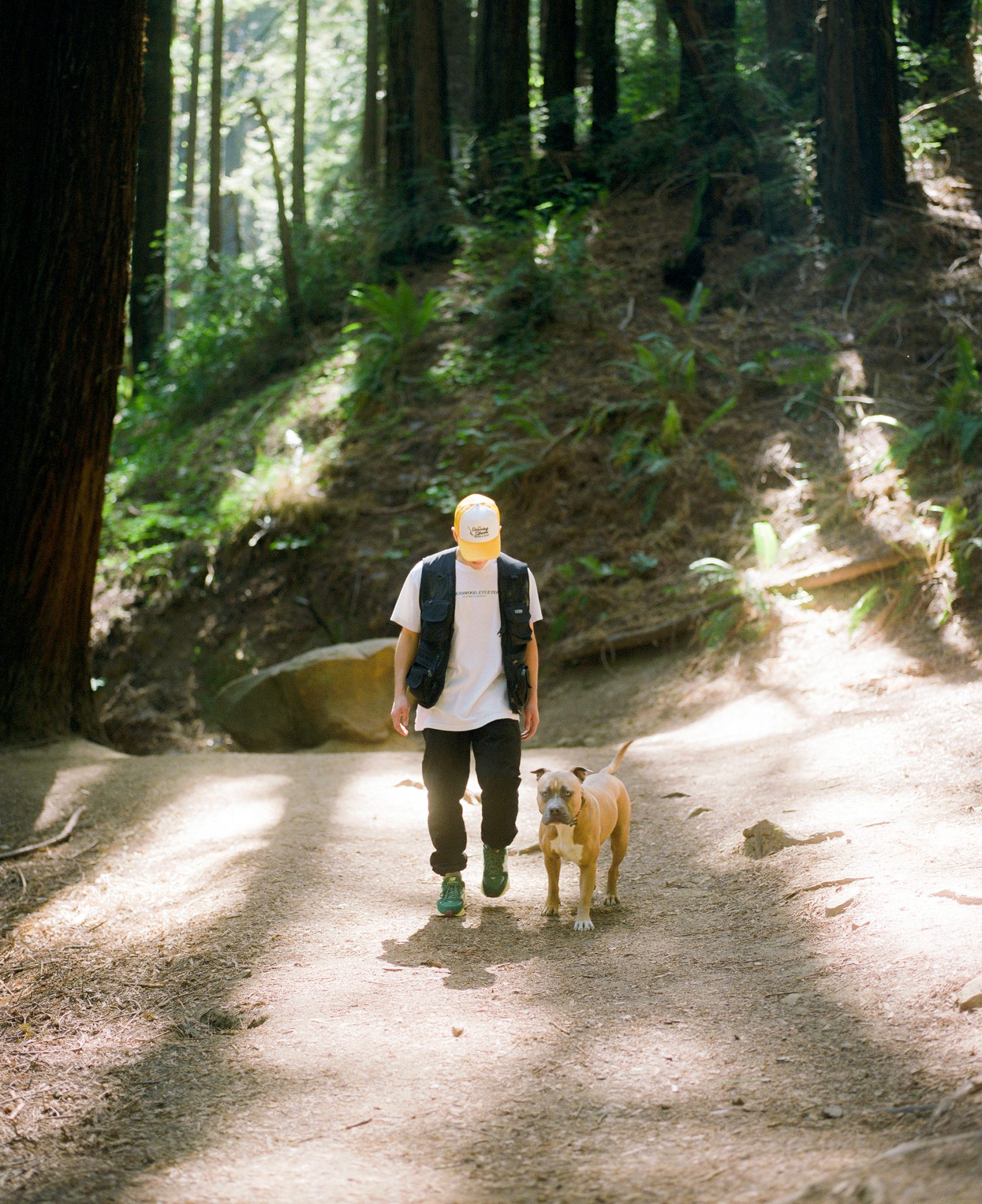 Kevin Wong wearing the Bricks & Wood x New Balance 57/40 and a Bricks & Wood eTc Tacoma t-shirt standing next to his dog Chibi.